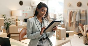 Women in a gray suit holding a tablet