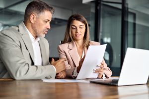 Business man and business woman reviewing paperwork