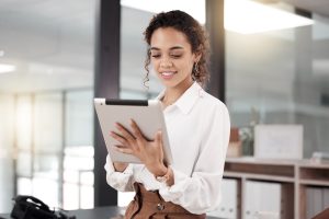 business woman in white button up holding a clipboard